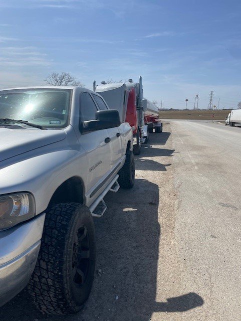 Service truck performing roadside assistance for semi-truck coolant leak